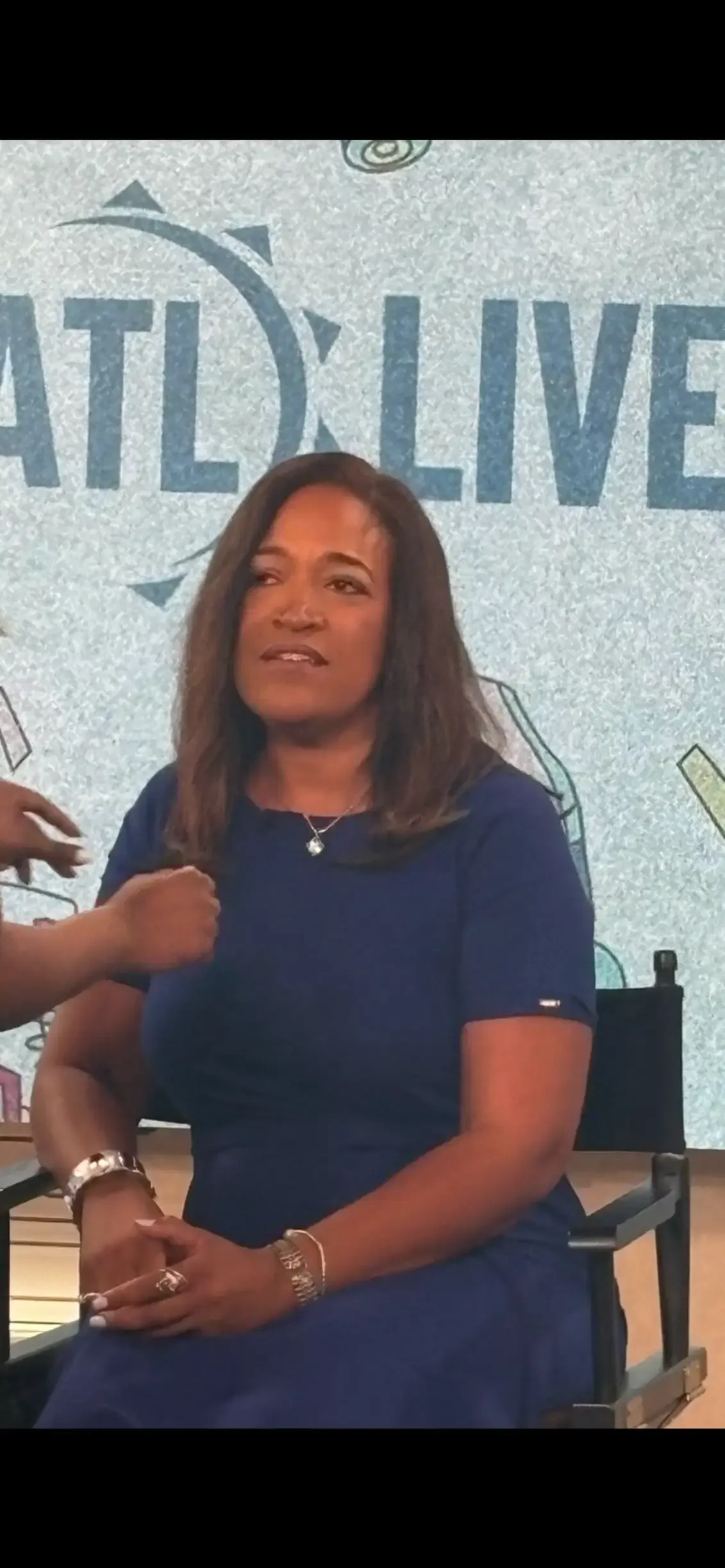 The television crew fitting Leah with a microphone before the interview